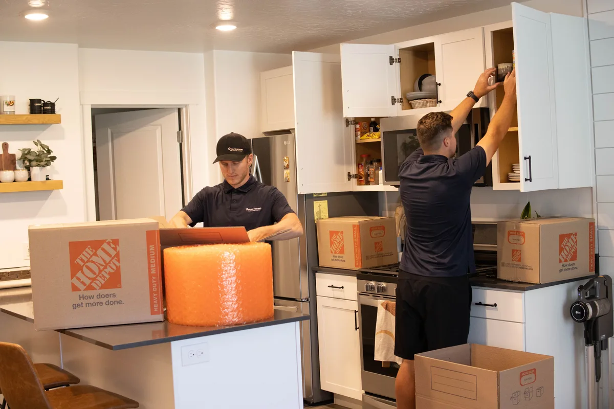 Utah's Moving & Storage crew member professionally packing kitchen items with care