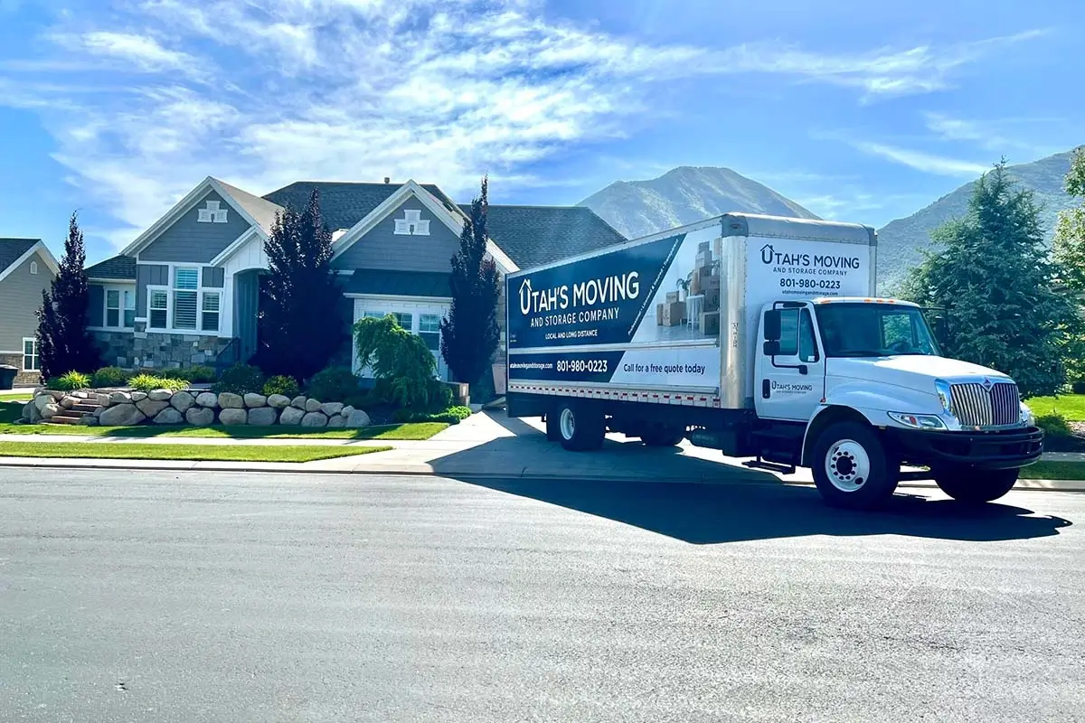 Utah's Moving and Storage moving truck parked outside a Utah home with mountain views